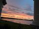 Picturesque sunset view over calm lake and cityscape at 8629 Saint Marino Blvd, Orlando, FL 32836