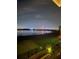 Night view of lake with illuminated Ferris wheel at 8629 Saint Marino Blvd, Orlando, FL 32836