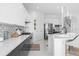 Modern kitchen with white and gray cabinets, a large island, and stainless steel appliances at 8629 Saint Marino Blvd, Orlando, FL 32836
