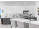 Modern kitchen with white and gray cabinets, a large island, and stainless steel appliances at 8629 Saint Marino Blvd, Orlando, FL 32836