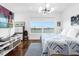 Main bedroom with lake view, hardwood floors, and stylish decor at 8629 Saint Marino Blvd, Orlando, FL 32836