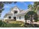 Two-story house with white exterior, grey roof and landscaping at 8629 Saint Marino Blvd, Orlando, FL 32836
