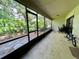 Screened porch with patio furniture and views of nature at 122 Crown Point Cir, Longwood, FL 32779