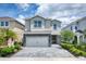 Two-story house with stone accents and a paved driveway at 171 Burma St, Kissimmee, FL 34747