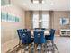 Elegant dining room with blue velvet chairs and modern light at 171 Burma St, Kissimmee, FL 34747