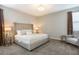 Spacious bedroom with king-size bed, seating area, and soft carpeting at 171 Burma St, Kissimmee, FL 34747