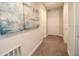 A hallway with light walls, carpeting, and artwork at 171 Burma St, Kissimmee, FL 34747
