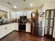 Modern kitchen with stainless steel appliances and dark wood flooring at 122 Crown Point Cir, Longwood, FL 32779