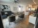 Open living space with a comfortable sectional sofa and stylish armchairs at 7416 Soiree Way, Reunion, FL 34747