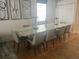 Elegant dining room featuring a large glass-top table and modern chairs at 7416 Soiree Way, Reunion, FL 34747