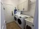 Convenient laundry room with washer, dryer, and utility sink at 7416 Soiree Way, Reunion, FL 34747
