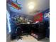 Superhero-themed bedroom with bunk beds, a desk, and a mural at 7416 Soiree Way, Reunion, FL 34747