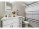 Updated bathroom with white vanity, shower, and striped curtain at 1149 Shady Cove E Rd, Haines City, FL 33844