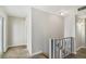 Upstairs hallway with carpet and gray railing at 1149 Shady Cove E Rd, Haines City, FL 33844