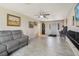Spacious living room with gray couch and tile floors at 1149 Shady Cove E Rd, Haines City, FL 33844