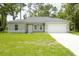 Single-story house with a two-car garage and well-maintained lawn at 6952 Sw 152Nd St, Ocala, FL 34473