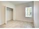 Bedroom with tile floors, closet, and window with blinds at 6952 Sw 152Nd St, Ocala, FL 34473