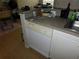 Kitchen features a dishwasher, white cabinets, and granite countertops at 824 Grand Regency Pt # 102, Altamonte Springs, FL 32714