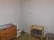 Bedroom with crib, dresser, and baby changing station at 824 Grand Regency Pt # 102, Altamonte Springs, FL 32714