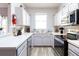 L-shaped kitchen with stainless steel appliances and light cabinets at 244 Capri Dr, Davenport, FL 33897