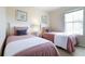 Bedroom with two twin beds, nightstand, and artwork at 244 Capri Dr, Davenport, FL 33897