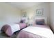 Bedroom with two twin beds, nightstand, and artwork at 244 Capri Dr, Davenport, FL 33897