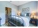 Cozy bedroom with a metal frame bed, nightstands, and artwork at 244 Capri Dr, Davenport, FL 33897