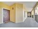 Condo hallway with dark brown door and tiled floor at 8801 Worldquest Blvd # 4406, Orlando, FL 32821