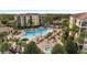 Resort-style pool and hot tub with plenty of lounge chairs and landscaping at 8801 Worldquest Blvd # 4406, Orlando, FL 32821