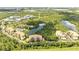 Wide aerial view of a condo community with a lake and lush surroundings at 8801 Worldquest Blvd # 4406, Orlando, FL 32821