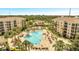 Resort-style pool with surrounding lounge chairs and palm trees at 8801 Worldquest Blvd # 4406, Orlando, FL 32821