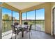 Screened balcony with lake view, table and chairs at 8801 Worldquest Blvd # 4406, Orlando, FL 32821