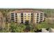 Exterior of a three-story condo building with tile roof and balconies at 8801 Worldquest Blvd # 4406, Orlando, FL 32821