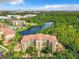 Aerial view of a condo building with resort-style amenities and a lake at 8801 Worldquest Blvd # 4406, Orlando, FL 32821