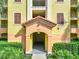 Building entrance with lush green landscaping on both sides of the walkway at 8801 Worldquest Blvd # 4406, Orlando, FL 32821