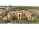 An aerial view of a residential building complex near a lake at 8801 Worldquest Blvd # 4406, Orlando, FL 32821