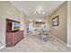 Bright dining area with glass table and chairs, open to kitchen at 8801 Worldquest Blvd # 4406, Orlando, FL 32821