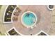 Relaxing hot tub surrounded by a brick patio and landscaping at 8801 Worldquest Blvd # 4406, Orlando, FL 32821