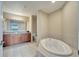 Bathroom boasts a large soaking tub and double vanity at 8801 Worldquest Blvd # 4406, Orlando, FL 32821