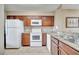 Kitchen with white appliances and granite countertops at 8801 Worldquest Blvd # 4406, Orlando, FL 32821