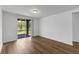 Living room with wood-look flooring and sliding glass doors at 3158 Viceroy Ct, Poinciana, FL 34759