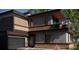 Modern home with dark exterior, balcony, and attached garage at 627 Country Club Dr, Winter Park, FL 32789