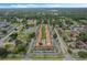 Aerial view showing apartment buildings, a pool, and surrounding landscape at 3651 N Goldenrod Rd # B107, Winter Park, FL 32792