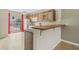 Galley kitchen with wood cabinets and pool view at 3651 N Goldenrod Rd # B107, Winter Park, FL 32792