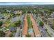 An aerial view showcasing apartment buildings, a pool, and parking areas at 3651 N Goldenrod Rd # B107, Winter Park, FL 32792