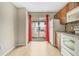 Kitchen with wood cabinets, white appliances, and sliding glass door to patio at 3651 N Goldenrod Rd # B107, Winter Park, FL 32792
