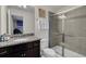 Bathroom with granite countertop, walk-in shower, and dark vanity at 1870 Summer Dr, Davenport, FL 33897