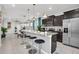 Open kitchen features granite countertops, stainless steel appliances, and breakfast bar at 1870 Summer Dr, Davenport, FL 33897