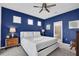 Spacious bedroom with blue walls, king-size bed, and ensuite bathroom at 1870 Summer Dr, Davenport, FL 33897