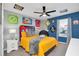 Bedroom with social media themed decor and a yellow comforter at 1870 Summer Dr, Davenport, FL 33897